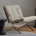 Modern Beige Tufted Lounge Chair With Metal Frame And Black Side Table On Wooden Floor