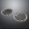 Two Round Metal Grilles With Striped Design On Dark Background