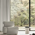 Modern Accent Chair by Dark Wood Cabinet with Light Gray Curtains and Autumn Tree Outside