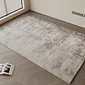 Textured Light Gray Square Rug on Herringbone Wood Floor with Open Magazine by Window