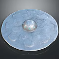 Circular Metallic Object With Central Raised Dome Petal Shaped Grooves Shiny Surface And Reflection Base