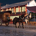 Ancient Architecture Scene With Black And White Horses Pulling Carriage And Red Lanterns At Night