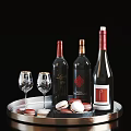 Wine Bottles and Wine Glasses Displayed on Silver Tray with Macarons