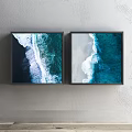 Two Framed Blue Ocean Wave Artworks Hung On Gray Wall