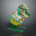 Colorful Reptile Metal Sculpture With Green Legs Yellow White Orange Floral Patterns And Spots