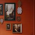 Orange Wall Decorated With Various Framed Paintings Mirrors And Ornate Decorative Items