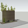 Wooden Landscape Wall with Vertical Slats Green Plants on Top and Stones at Base