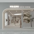 Modern Fashion Gallery Interior With Mannequins Clothing Displays Warm Lighting And Small Tree