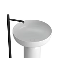 Two Black and White Pedestal Washbasins with Black Faucets and Gold Base Accents