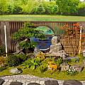 Rockery Stones in Garden Landscape with Green Plants Deer Statue Bamboo Fence and Circular Decoration