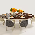 Round Dark Tabletop Dining Table and Chairs Set With Orange Flower Bouquets