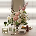 Pink and White Blooms in Glass Vase with Perfume Bottles Candles and Window Blinds