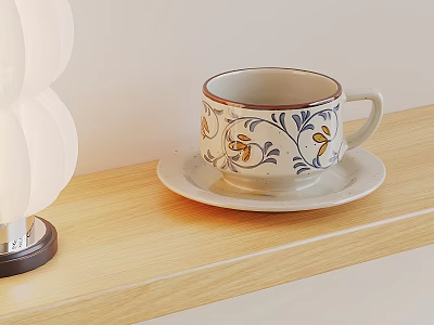 Ceramic Cup With Blue Yellow Floral Pattern On Saucer Beside White Lamp Wooden Shelf 3d model
