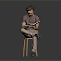 Man Sitting On Wooden Stool Reading Book In Purple T-Shirt And Khaki Pants