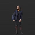 Woman in Dark Blue Blazer and Black Dress with Dark Blue Backpack Against Dark Background