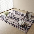 Square Rug with Polka Dot Pattern on Wooden Floor Featuring Vase Flowers and Window Blinds