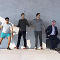 Group of People Leaning Against Gray Wall In Various Poses With Different Clothing