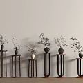 Stylish Wooden and Metal Plant Stands with Potted Plants Against Light Wall and Wooden Floor