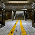 Subway Station Interior With Metallic Pillars Staircase Yellow Lines And Tiled Floor