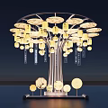 Tree Shaped Art Installation With Illuminated Yellow Lanterns And Round Base Decorations