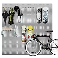Pegboard Wall with Hanging Umbrellas Coats Scarves Skateboards and Bicycle Leaning Against