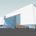 Modern Commercial Complex Featuring Glass Curtain Walls White Exterior And Open Entrance Area