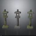 Three Stone Lanterns With Mossy Green And Light Stone Bases And Rounded Tops