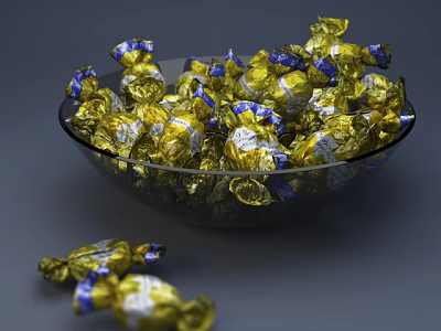 Golden And Blue Wrapped Candies In Transparent Glass Bowl With Scattered Pieces 3d model
