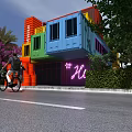 Colorful Modern Container Building with Neon Hu Sign Surrounded by Greenery People Riding Bicycles Nearby
