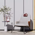 Gray Upholstered Leisure Chair With Leather Accents Side Table Vase Green Plant In Modern Interior