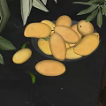 Fresh Yellow Mangoes in Glass Bowl with Green Leaves on Black Background