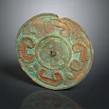 Ancient Bronze Mirror Featuring Intricate Patterns Greenish Patina And Red Motifs