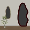 Two Unique Shaped Mirrors With Golden And Dark Red Frames Near Green Plant