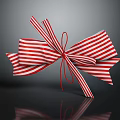 Decorative Ornament Set with Red and White Striped Bow Shiny and Reflective on Dark Surface