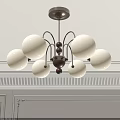 Modern Chandelier with White Spherical Shades and Walnut Center on White Wall with Decorative Molding