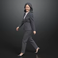 Professional Business Woman in Gray Suit and White Shirt Walking Confidently Against Black Background