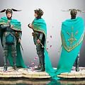 Warrior Character In Blue Cloak With Gold Patterns Winged Helmet Weapon Pink Petals Circular Base