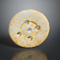 Round Yellowish Object With Multiple Holes And Rough Surface On Gray Background