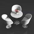 Modern Tea Break Area With Round White Table Pink White Flowers And Three Curved Chairs