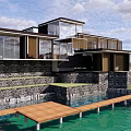 Modern Vacation Villa Building with Green Roof Glass Walls Wooden Walkway on Sloped Waterfront Terrain