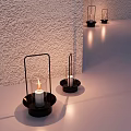 Decorative Ornament Combination Of Black Metal Candle Holders With Lit White Candles In Various Sizes