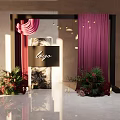 Elegant Floral Installation With Black Frame Purple Curtains And Logo Sign