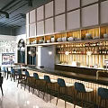 Elegant Restaurant Interior With Bar Counter Wine Bottles Bowls On Shelves And Blue Bar Stools