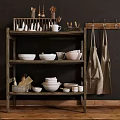 Rustic Wooden Shelving Unit Holding Bowls Mugs Plates and Hanging Aprons Against Dark Wall