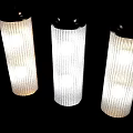 Modern Wall Lamps With Gold And Silver Frames And White Vertical Ribbed Shades On Wall