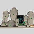 Elegant Green Emerald Jewelry Display With Pendants Bracelets And Rings On Gray Mannequin Stand