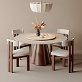 Round Wooden Dining Table With Four Chairs Light Colored Cushions Vase Flowers And Hanging Lamp