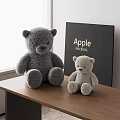 Large Gray And Small Light Gray Teddy Bears On Wooden Table With MacBook Box
