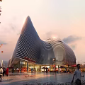 Modern Streamlined Public Building With Curved Metal Facade And Evening Pedestrian Area