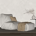 Gray Bean Bag Chair With Beige Cushion Brown Blanket Ottoman Side Table And Dried Branches